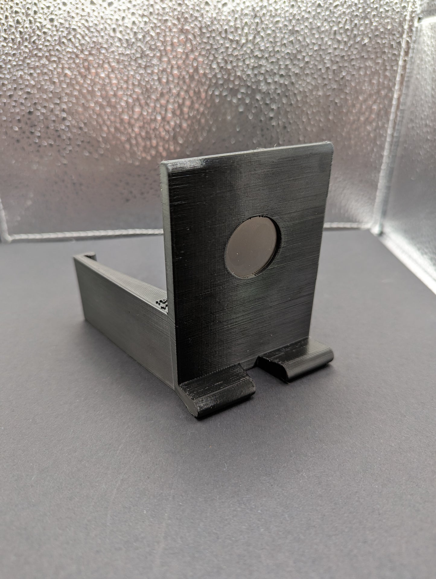 A black phone mount for a Dodge Ram vehicle, showing the mount by itself.  3D printed
