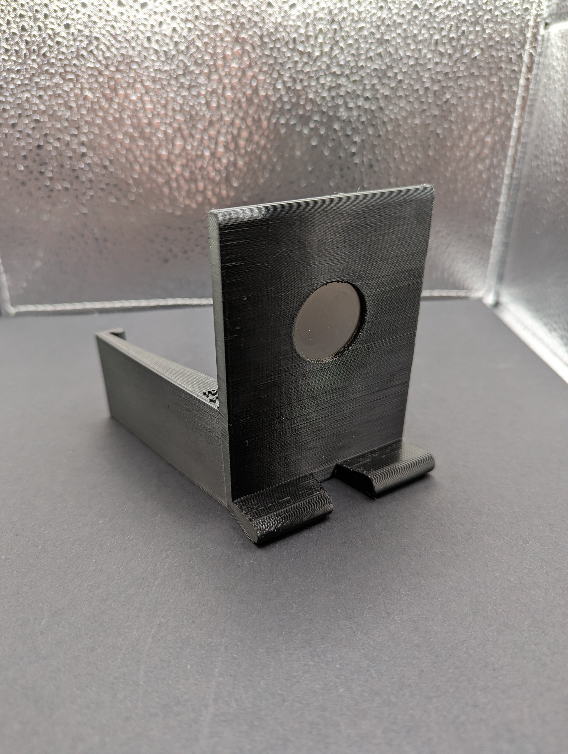 A black phone mount for a Dodge Ram vehicle, showing the mount by itself.  3D printed